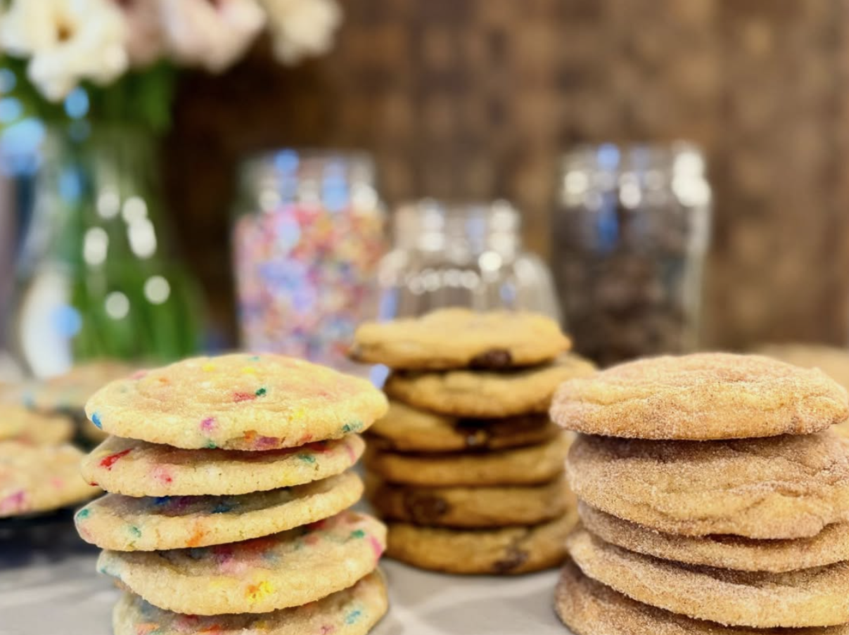 Stacks of Kara’s sprinkle, chocolate chip, and cinnamon sugar cookies